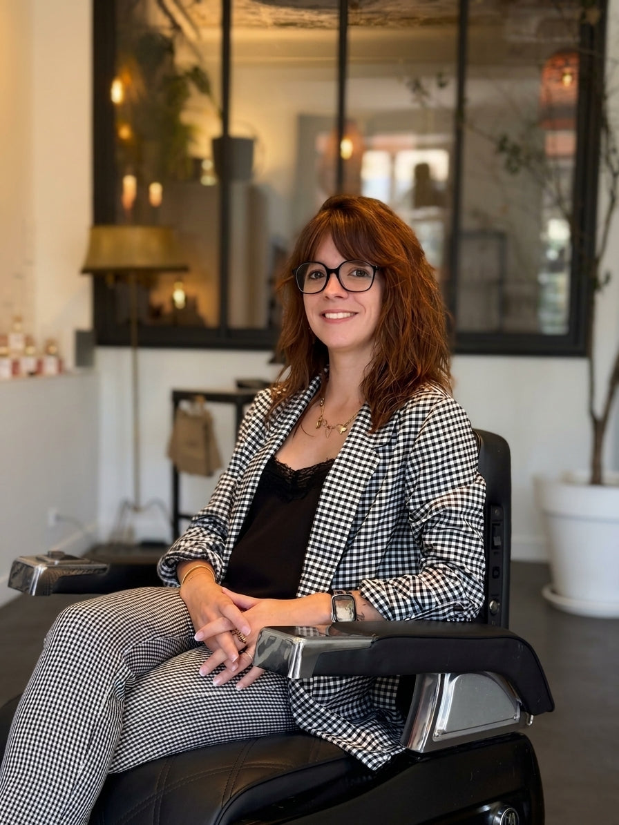 Marine Riffaudeau seated in a barber chair at Maison Héritage.