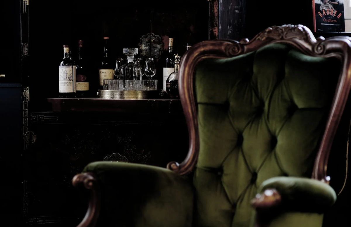 Velvet armchair and table in the Social Club at Maison Héritage.
